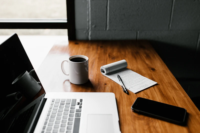 A quiet workspace with a notebook and laptop