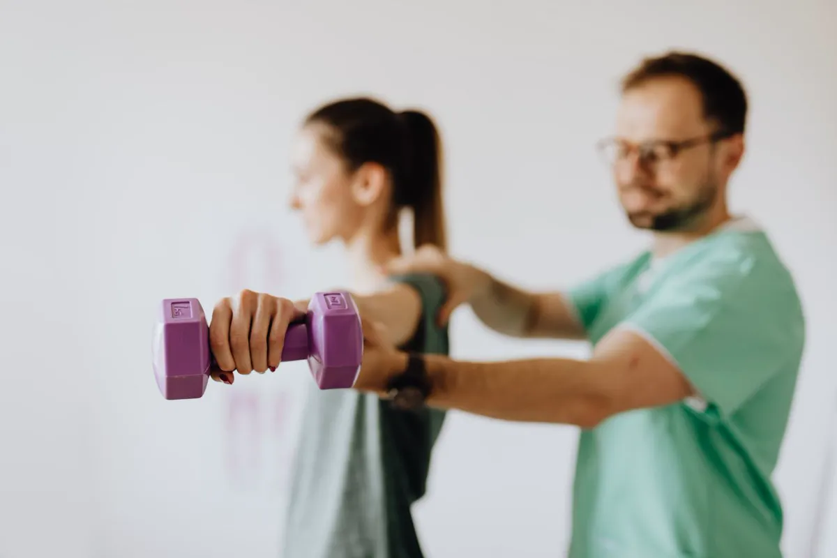 A physiotherapist guiding a patient through a resistance exercise