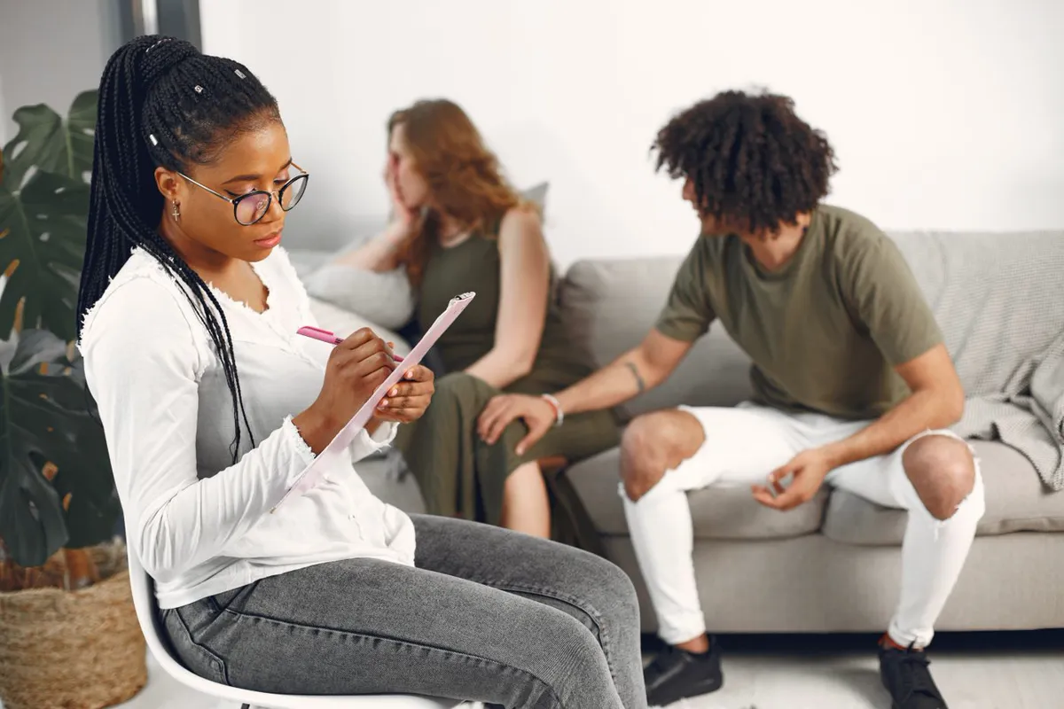 A counsellor taking notes during a session